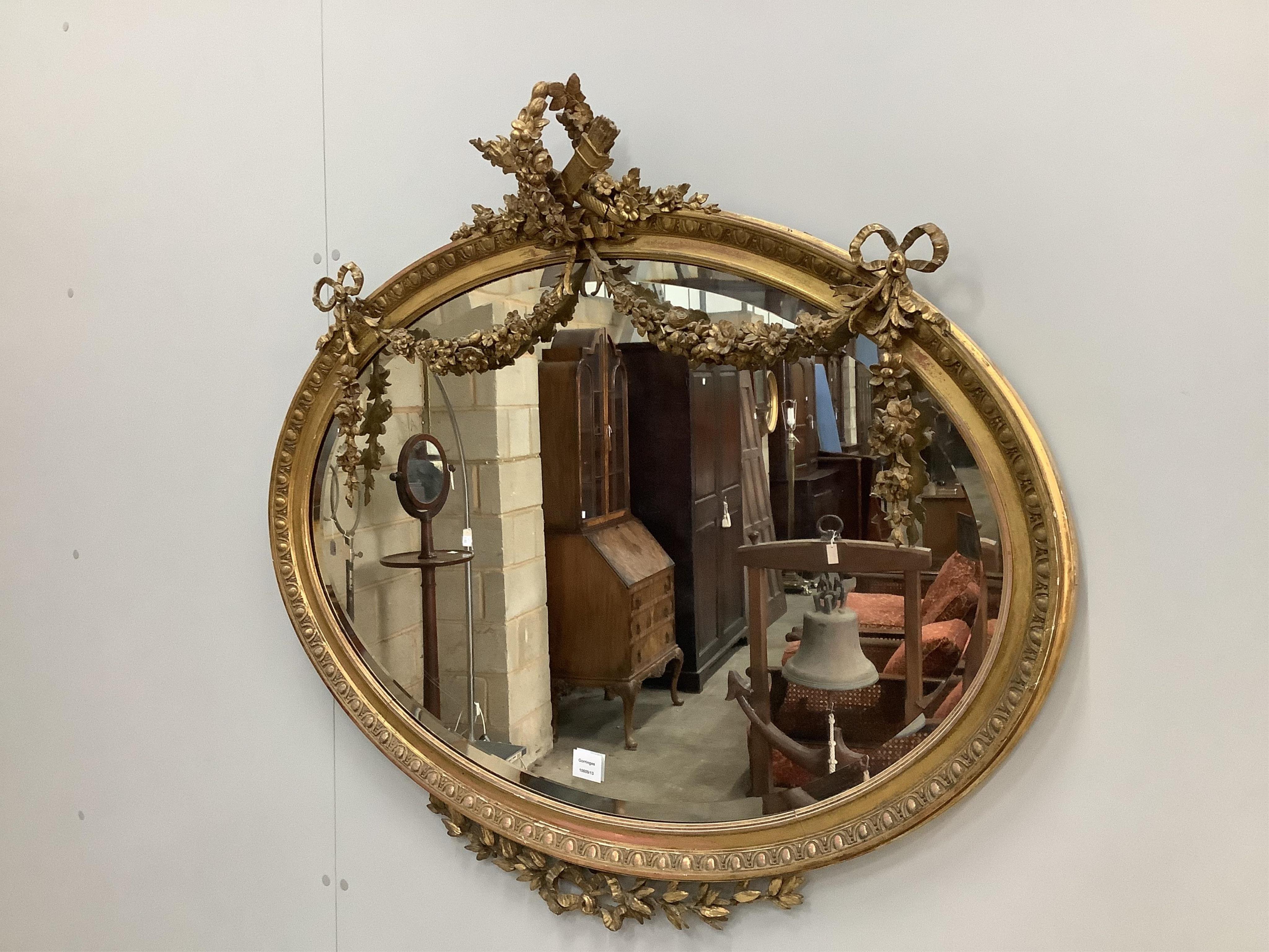 An Edwardian oval giltwood and composition wall mirror, width 105cm, height 95cm. Condition - fair to good